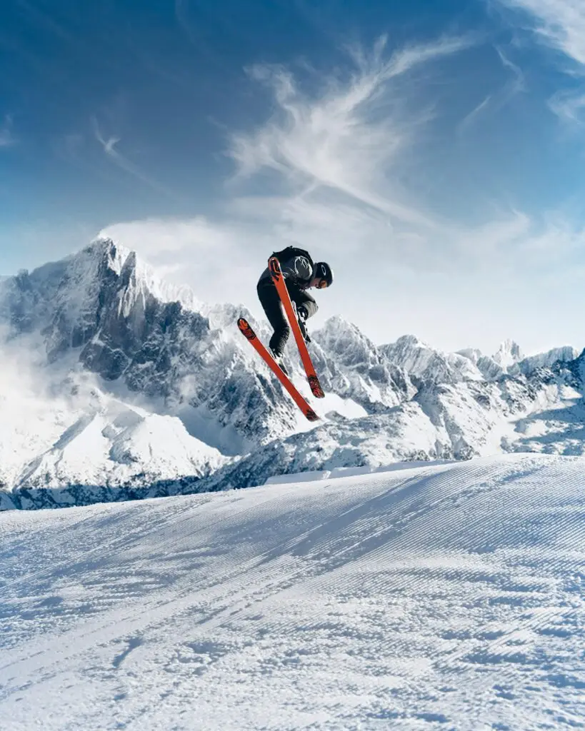 Sustainable skiing - skier jumping in the snowy mountains