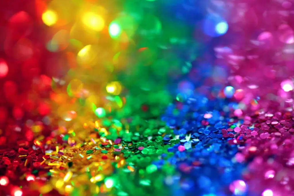 Layers of glitter in different colours: red, yellow, green, blue and purple.